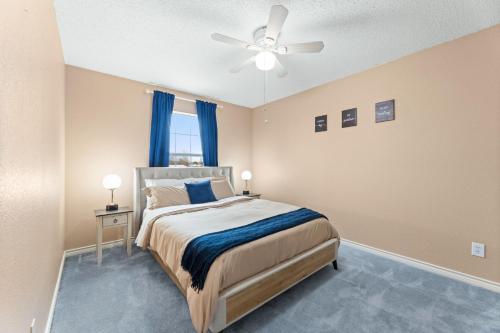 a bedroom with a bed and a ceiling fan at Hackberry Hideaway in Frisco