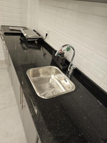 a kitchen counter with a stainless steel sink at Family Stay Ourzazate - Deluxe Appartments in Ouarzazate