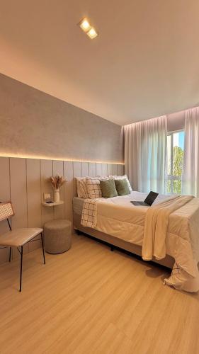 a bedroom with a large bed and a window at Apartamento Villa Park Natal in Natal