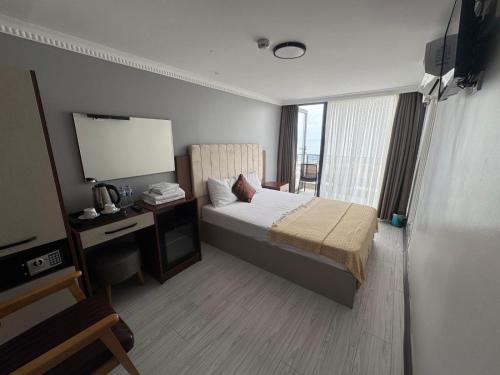 a hotel room with a bed and a mirror at istanbul Airport Kumsal Otel in Arnavutköy