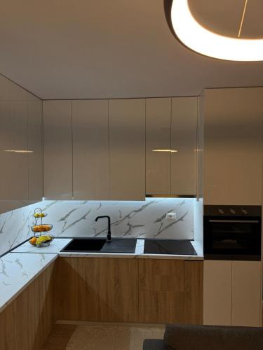 ドゥラスにあるIdeal Apartmentのシンクとカウンタートップのあるキッチン