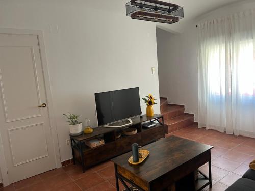 a living room with a television and a table at Casa Julio Tordesillas in Tordesillas