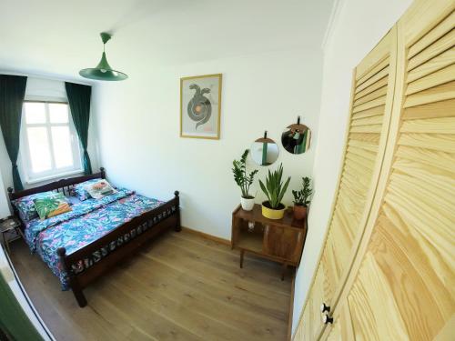 a bedroom with a bed and a window and a door at Stacja Srebrna Góra in Srebrna Góra