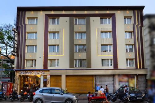 a large building with cars parked in front of it at Hotel Grand Plaza in City Centre - Walking Distance From New Delhi Railway Station and Connaught Place in New Delhi