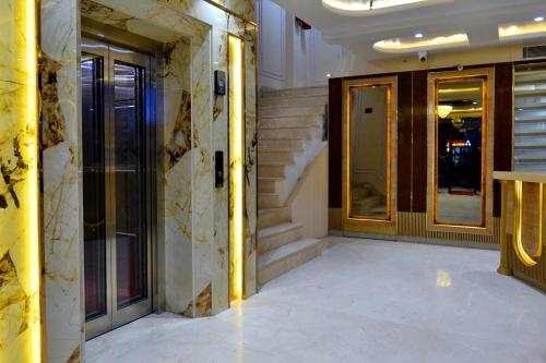 a hallway of a building with stairs and doors at Hotel Grand Plaza in City Centre - Walking Distance From New Delhi Railway Station and Connaught Place in New Delhi