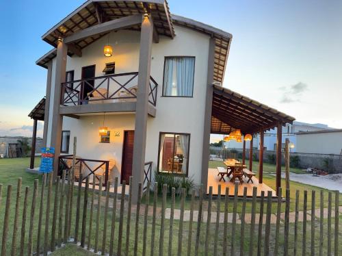 a house with a fence in front of it at Chalé Paraíso Santo Amaro in Santo Amaro