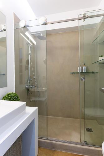 a shower with a glass door in a bathroom at Ma Maison No5, Private Heated Pool, Acropolis View in Athens