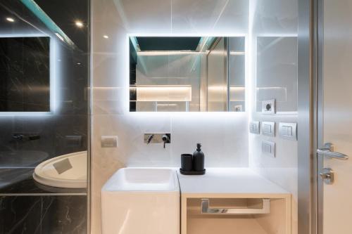 a bathroom with a sink and a toilet at Suites 1955 in Cagliari