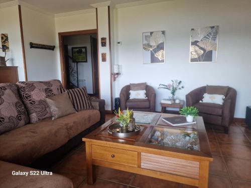 a living room with a couch and a coffee table at O Piñón in Santa Cristina de Cobres