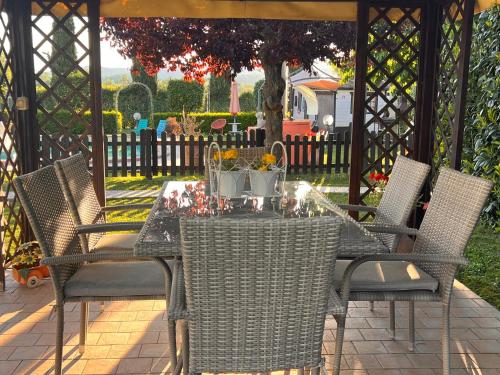 an outdoor table with chairs and a gazebo at RelaxHomeHoliday in Panicale