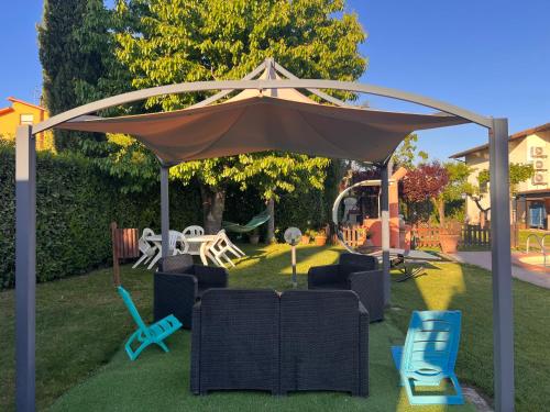 a gazebo with chairs and chairs in a yard at RelaxHomeHoliday in Panicale