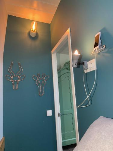 a bedroom with a blue wall with deer decals on the wall at Appartement op woonboot hartje centrum in Amsterdam