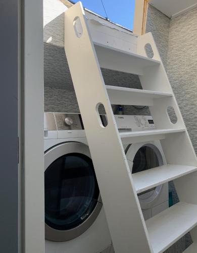 a white washer and dryer in a room at Appartement op woonboot hartje centrum in Amsterdam