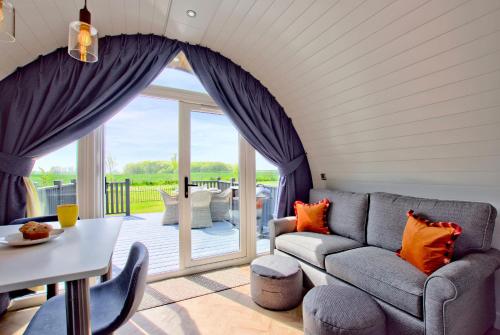 a living room with a couch and a table at Hollins Farm - Dog Friendly, Self Catering Holiday Lodges in Knaresborough