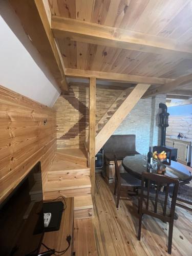 a room with a table in a room with wooden walls at House Luka Zabljak Borje in Međužvalje