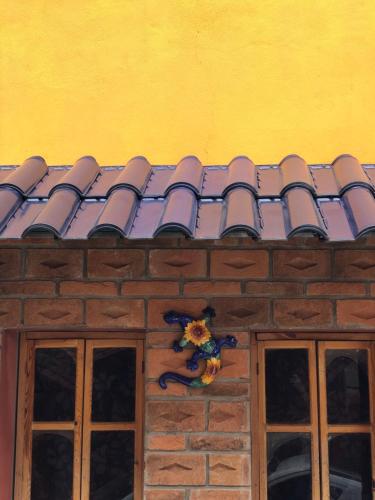 a tiled roof on a building with two windows at Hotel JADE in Mesa Colorada