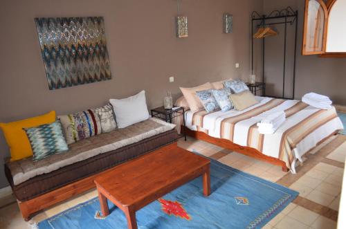 a living room with two beds and a couch at Casa Naima in Ida Ougourd