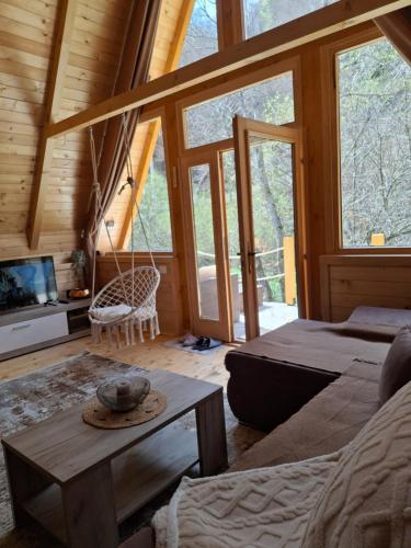 a room with a bed and a couch and a table at Holiday Home Veruša in Podgorica