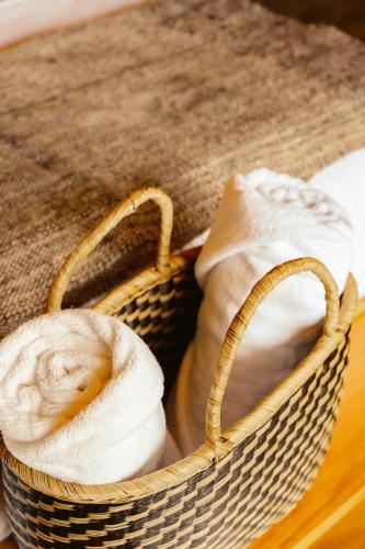 a basket filled with towels on top of a table at Hotel Casa Selvaggio in Ráquira