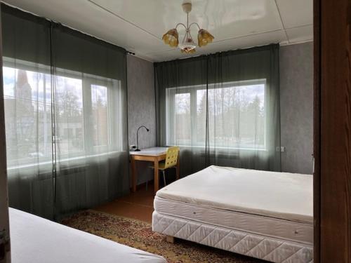 a bedroom with two beds and a desk in it at Kastan House in Mustvee