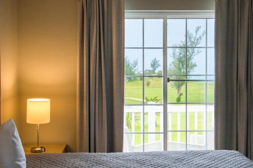 a bedroom with a bed and a window with a view at St George's Club in Saint George