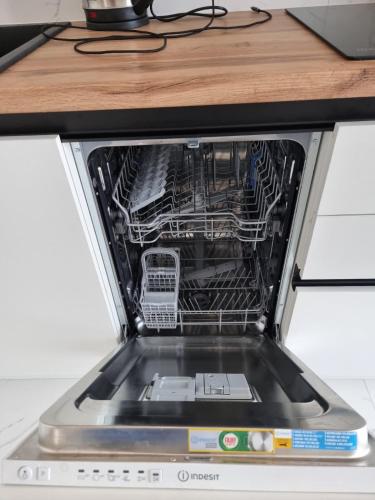 a dishwasher with its door open on a counter at ЖК Яровиця Люкс 13 поверх in Luts'k
