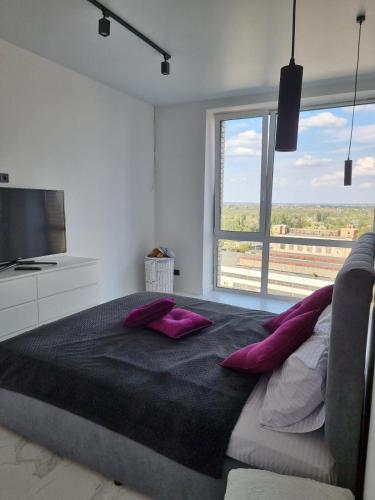 a bedroom with a large bed and a large window at ЖК Яровиця Люкс 13 поверх in Luts'k