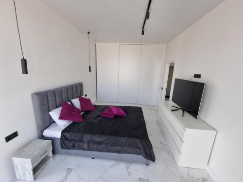 a bedroom with a bed and a flat screen tv at ЖК Яровиця Люкс 13 поверх in Luts'k
