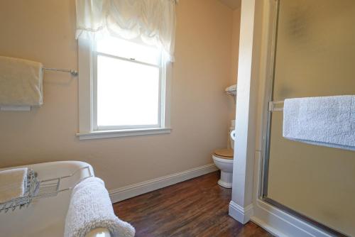 a bathroom with a toilet and a window at Weaverville Hotel in Weaverville