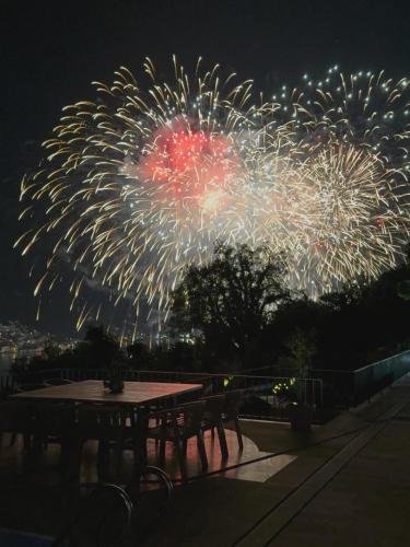 a firework display at night with a picnic table and a table sidx sidx sidx at Villa Invicta with 17m pool and bay view in Kotor