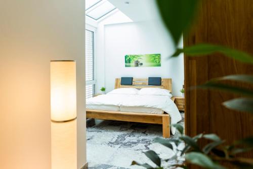 a bedroom with a bed in a room at Dreamapartment La Vigna "Stone" Suite mit eigenem Indoorpool & Sauna & Grillhütte - Weil am Rhein in Weil am Rhein