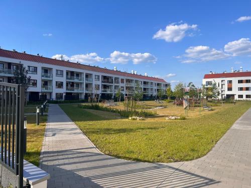 a large building with a park in front of it at Apartament Wilanow in Warsaw