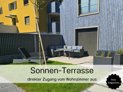 a picture of a patio with a table and chairs at Ferienhausträume-Bodensee Bergstrassen Apartments in Kreuzlingen