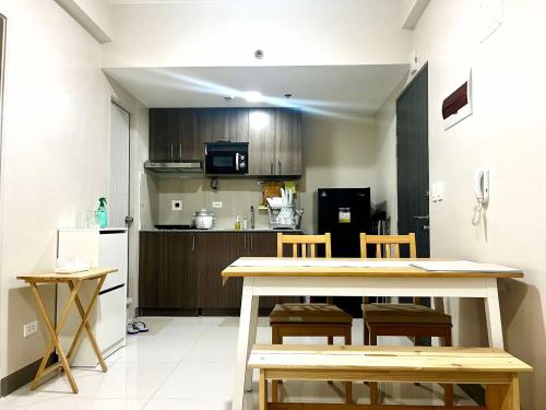 a kitchen with a table and chairs in a room at Condo near Intramuros, Manila in Manila