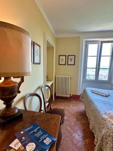 a bedroom with a bed and a table with a lamp at Villa Adelaide Lakeview in Como