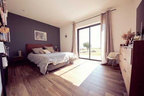 une chambre avec un lit et une grande fenêtre dans l'établissement Contemporary villa, panoramic sea view, à Corbara