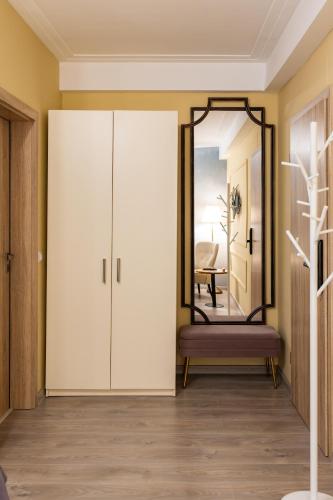 a dressing room with a mirror and a bed at HerMira House in Sibiu