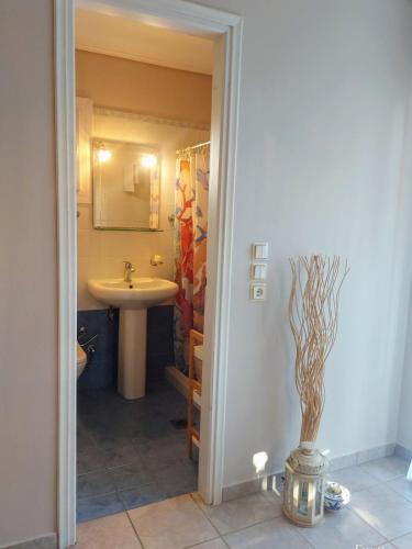a bathroom with a sink and a toilet and a sink at Octopus Garden, Koralli Studio in Travliáta
