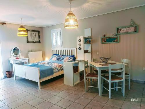 a bedroom with a bed and a table and a desk at Octopus Garden, Koralli Studio in Travliáta