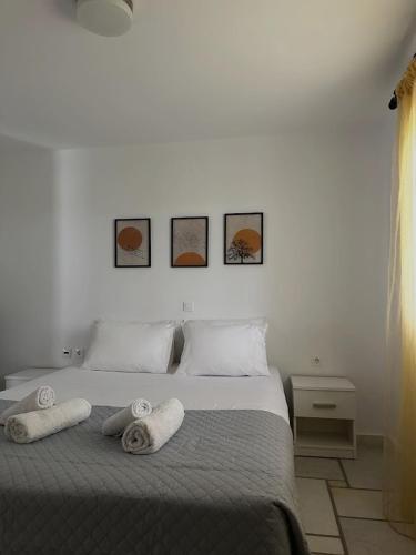a bedroom with a bed with towels on it at Barewake 's place Charming Retreat - Calm escape Apt in Kamári