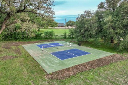 an overhead view of a tennis court in a field at Stunning 2-Story Container Home with Rooftop Terrace in Bellmead