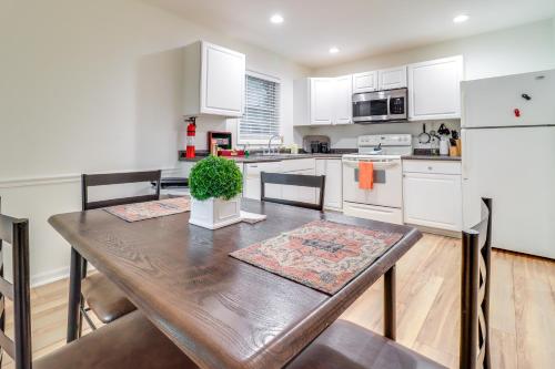 a kitchen with a wooden table with a potted plant on it at 7 Mi to Downtown Toledo Apt Near Franklin Park in Toledo