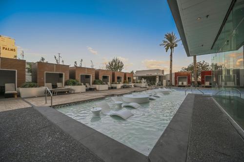 a swimming pool with chairs in the middle of a building at StripViewSuites at Palms Place in Las Vegas
