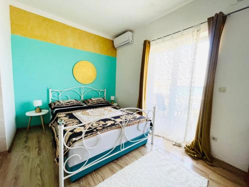 a bedroom with a bed and a blue wall at Apartments Esperanza in Pašman