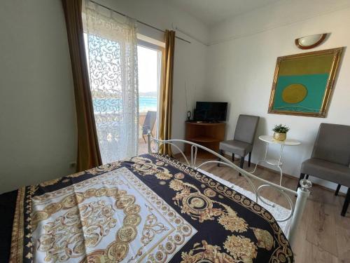 a bedroom with a bed and a large window at Apartments Esperanza in Pašman