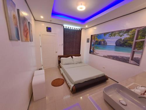 a small bedroom with a bed and a sink at Weigel's Beach House in Asturias