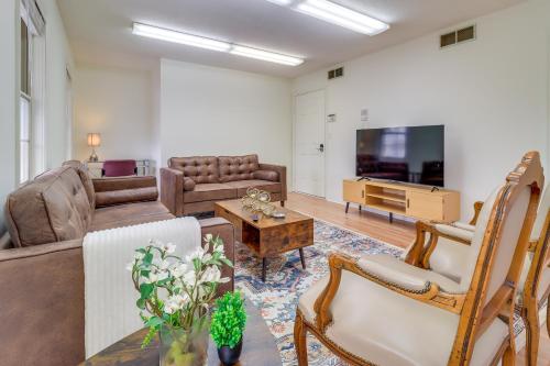 a living room with a couch and a tv at 7 Mi to Downtown Toledo and Riverfront Cozy Apt! in Toledo