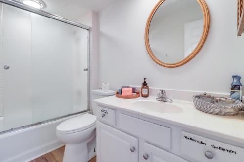 a bathroom with a sink and a toilet and a mirror at 7 Mi to Downtown Toledo Apt Near Franklin Park in Toledo