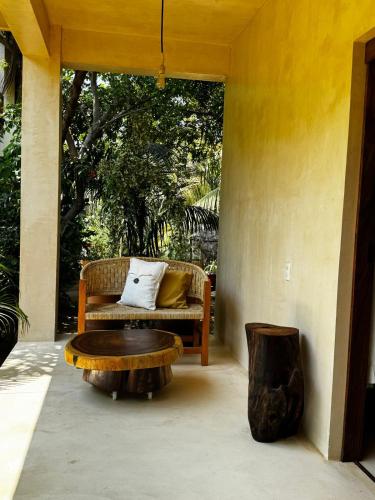 a porch with a couch and a coffee table at Casa Mariposa Beach Hotel in Tierra Blanca