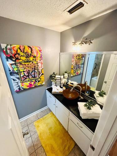 a bathroom with a sink and a large mirror at Entire home in Dothan, Alabama in Dothan